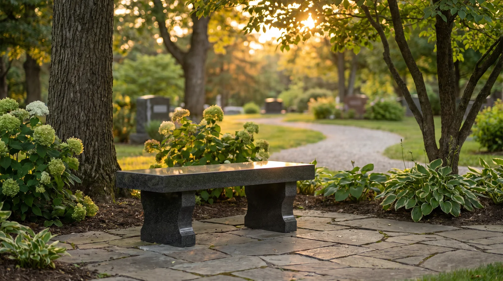 Polished granite memorial bench in a garden-style cemetery setting